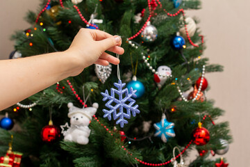 woman decorates christmas tree, christmas
