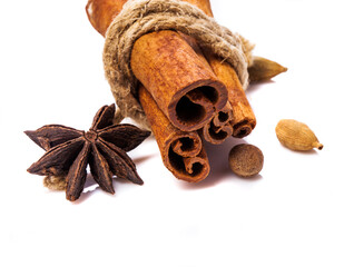 Cinnamon sticks and spieces close up on wooden table. Dark style