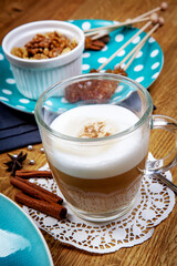 Fragrant spices, coffee, cinnamon and marshmallow on turquoise ceramic plate.Top view.