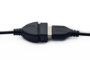 Black usb type-A male and female cable on a white background with a symbol in one of the connections, you can see part of the cable and the two connectors with the gold metal terminals.
