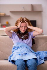 Obraz premium Young woman suffering at home