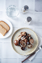 Gruzdi mushrooms with pickled onion and garlic.