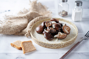 Gruzdi mushrooms with pickled onion and garlic.