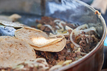 Beef tacos with onion, cilantro and salsa. Street tacos. Mexican tacos. Street sale of tacos.