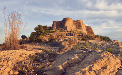 View of a castle on top of the mountain at sunset. Sagunto Castle