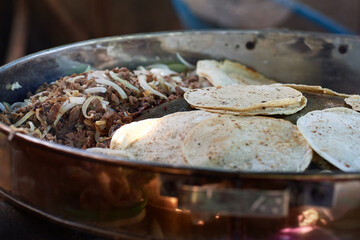 Beef tacos with onion, cilantro and salsa. Street tacos. Mexican tacos. Street sale of tacos.