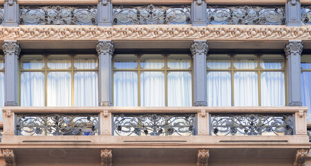 wrought iron decorations, art deco building facade in Milan, Italy.