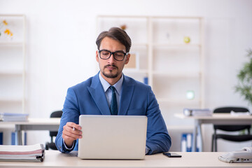 Young male employee working in the office