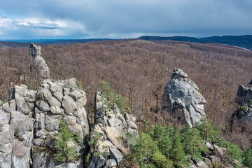 Aerial view to Dovbush Rocks in Bubnyshche at sunrise. Legendary ancient cave monastery in fantastic boulders amidst beautiful scenic forests in Carpathian Mountains, Ukraine