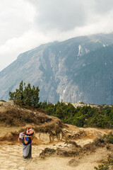 woman carries gas in hamalayas, nepal