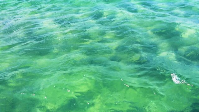 Sea sandy bottom with sun glare. This is what the sea looks like when you go into the water for swimming