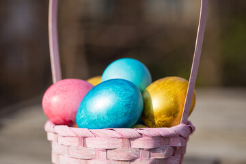 Pink easter basket with eggs on a background of green grass.