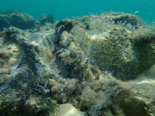 Waste from textile at the bottom of the sea, Aegean Sea, Greece, Halkidiki. Sea pollution.
