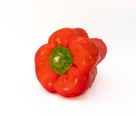 ripe with drops of water red pepper isolated on light background