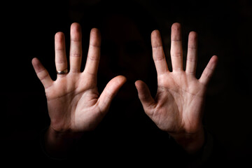 female palms aimed at the camera on a black background.