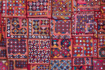 Detail old colorful patchwork carpet in India. Close up