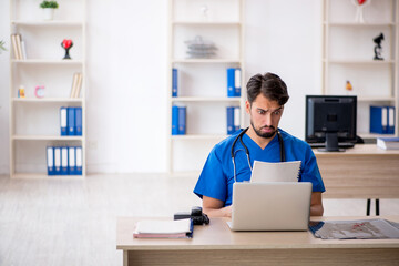 Young male doctor working in the clinic