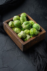 Brussels sprouts, on black textured background
