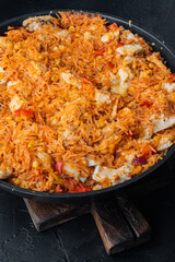 Enchilada with tomato rice, a mexican recipe, on black background