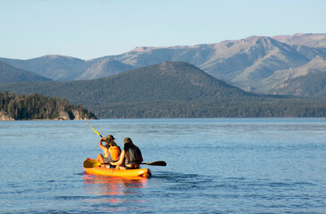 Two women rowing in kayak in the lake