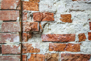 Embossed textured surface of an old wall made of facade bricks and cement