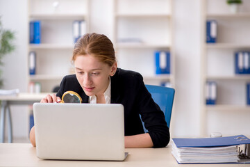 Young female employee working in the office