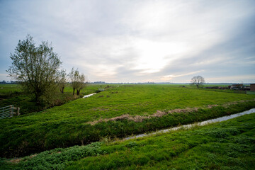 Fototapeta na wymiar Landscape picture of a ditch and farmlands