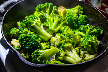broccoli in a frying pan. Broccoli roasting