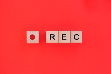 Recording sign, red panel, rec. Rec word on wooden cube blocks