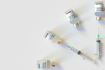 Clock face made with hepatitis vaccine vials and syringes. Vaccination time concept. Conceptual medical 3D rendering