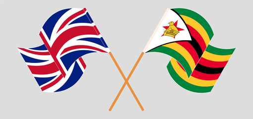 Crossed and waving flags of United Kingdom and Zimbabwe