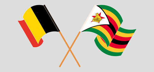 Crossed and waving flags of Belgium and Zimbabwe