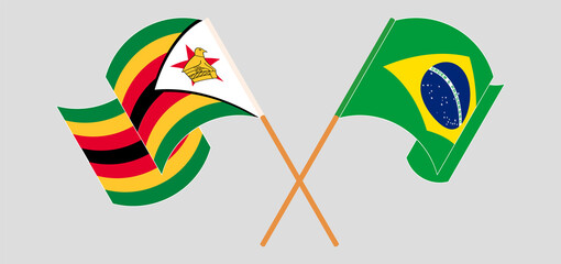 Crossed and waving flags of Zimbabwe and Brazil