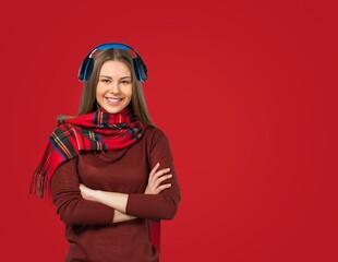 Christmas music. Pretty young woman in headphones and winter outfit