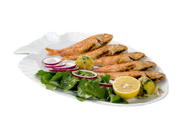 barbun fish on white dish with greens