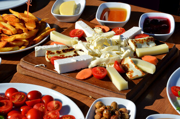 turkish breakfast with cheese tomato sausage jam patato olive cucumber
