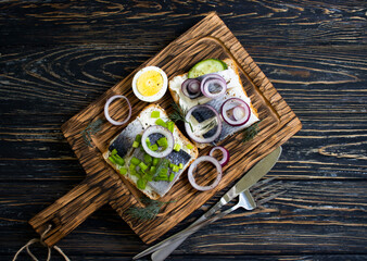 herring sandwich blue onion on wooden background