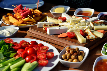 turkish breakfast with cheese tomato sausage jam patato olive cucumber