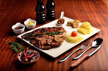 grilled meat with mashed potatoes on wooden table