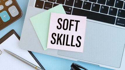 Text SOFT SKILLS on sticker with keyboard , pencils and office tools