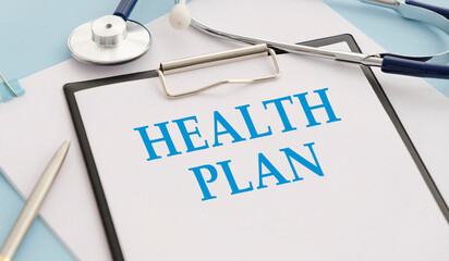 holding a sign which says health plan and showing space for text with pen, isolated on white background - obrazy, fototapety, plakaty