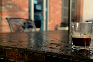 A cup of espresso sits on the table