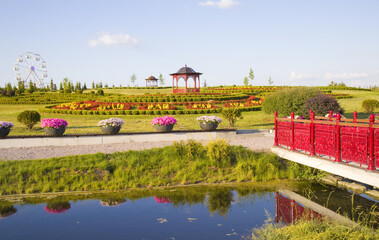 Landscape with oriental pavilion, green meadow and blue sky in the park