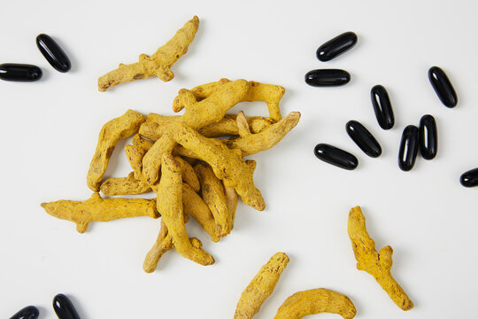 Dried Turmeric Root With Omega 3 Fatty Acids Soft Gel On White Background