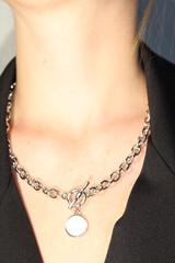 Necklace with vintage pendant at the beautiful woman's neck