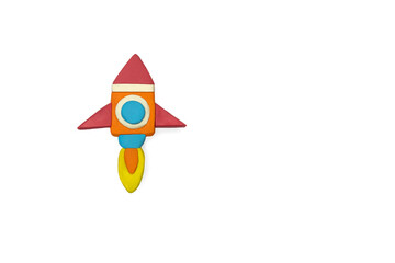 Plasticine space rocket on a white background. Travel or space flight concept. A rocket molded from...