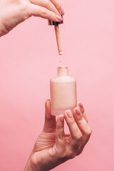 hand holds a bottle of varnish