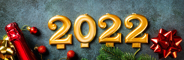 2022 number with champagne bottle and decor. Happy new year and festive concept. Top horizontal...