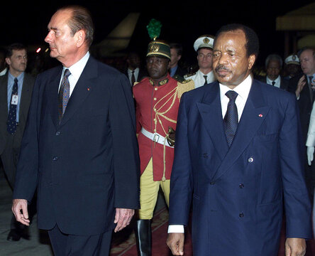 French President Jacques Chirac (L)  and Cameroon President Paul Biya (R) review the honour guard as..