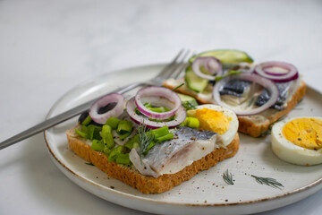 herring sandwich blue onion on wooden background